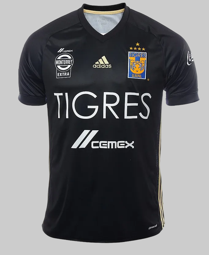 Detalle de la parte frontal del jersey third Adidas Tigres UANL 2017 con el escudo del club, logo de Adidas y patrocinador central en tonos dorados y blancos, stock Futbol90MX