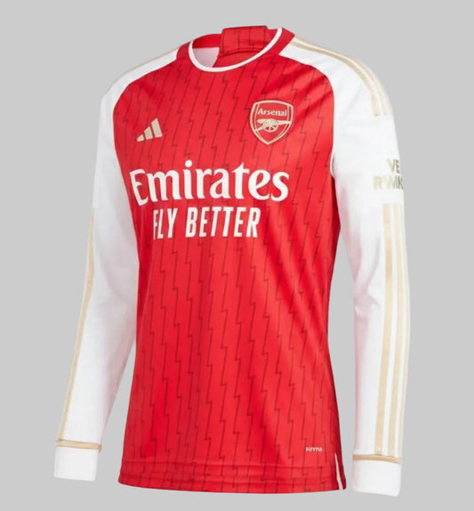 Vista frontal del Jersey de local de manga larga Adidas Arsenal 2023/24 en rojo y blanco con detalles dorados, exhibida sobre fondo neutro, codigo HZ2085, disponible en Futbol90MX