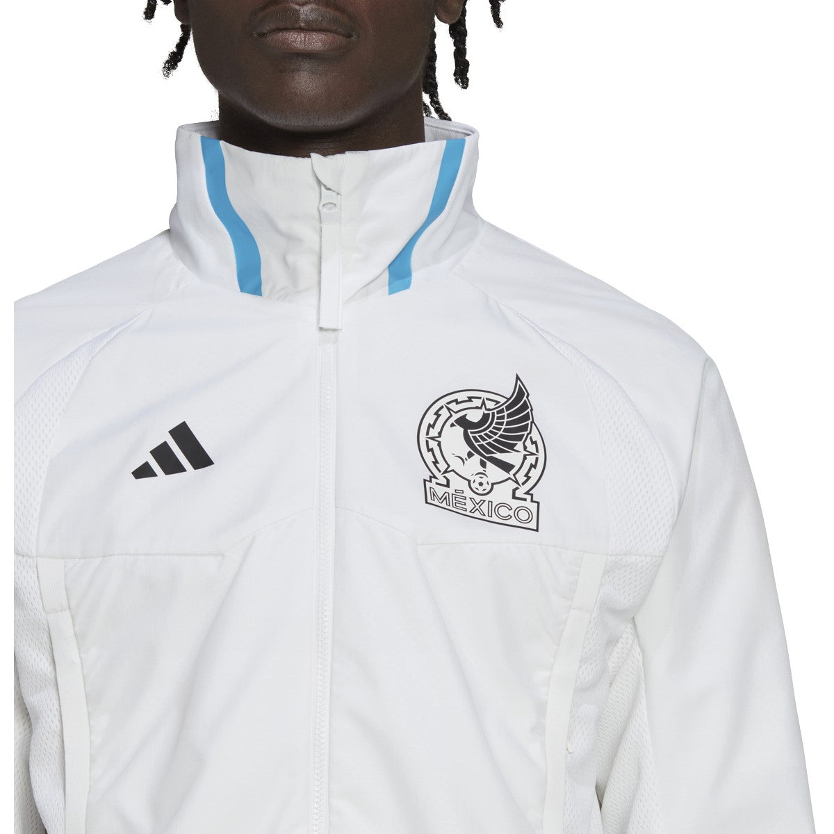 Detalle del escudo aplicado de la Selección Mexicana de Fútbol con coloración monocromatica sobre tejido técnico de la chamarra Anthem 2022. Autenticidad verificada por Futbol90MX.