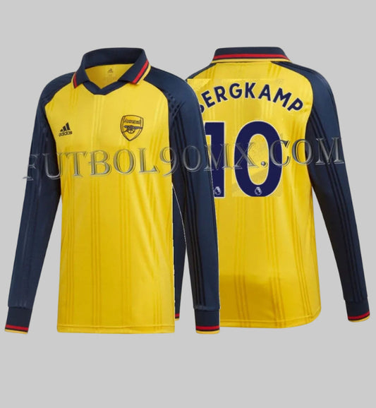 Vista dual del jersey retro Arsenal FC, edición Icons de Dennis Bergkamp con el nombre 'BERGKAMP' y el número '10' impresos en azul marino, codigo EH5614, disponible en Futbol90MX