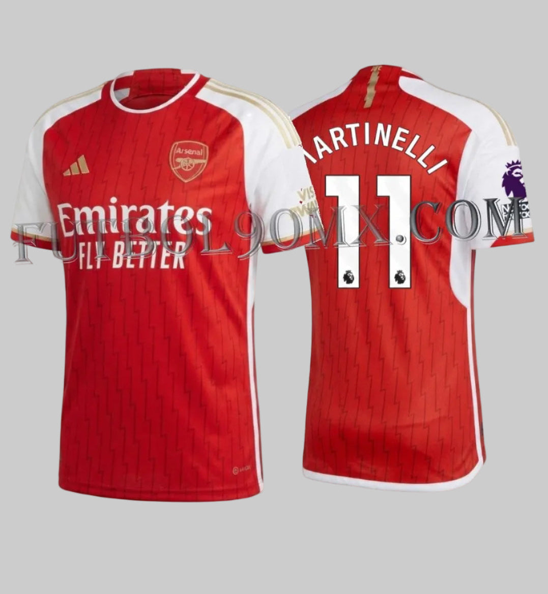 Vista dual del jersey Adidas Authentic Match Home del Arsenal FC 2023/24, personalizado con el número 11 de Gabriel Martinelli. Se observa el patrón gráfico de rayos, detalles dorados y la tecnología HEAT.RDY de alto rendimiento, codigo HR6931, disponible en Futbol90MX