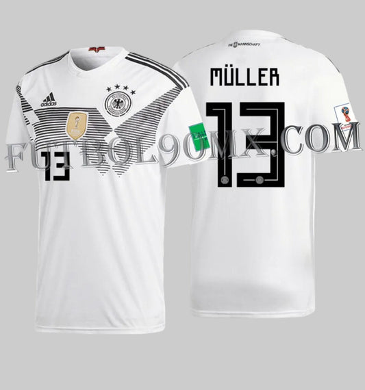 Jersey Alemania local con dorsal oficial MULLER 13 en tipografía Adidas Mundial 2018 y parches autenticos del torneo BR7843. Estampado en vinilo térmico original, estado 10/10 preservado para el Archivo Histórico de Futbol90MX.