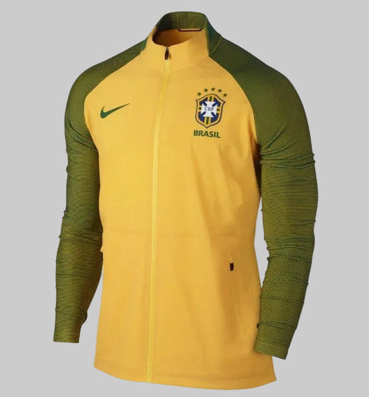 Vista frontal de la chamarra Nike Brasil Woven Elite Revolution Copa América Centenario 2016 (Ref. 802447-703) en Futbol90MX, destacando su diseño en color amarillo Canarinha y mangas texturizadas en verde oscuro