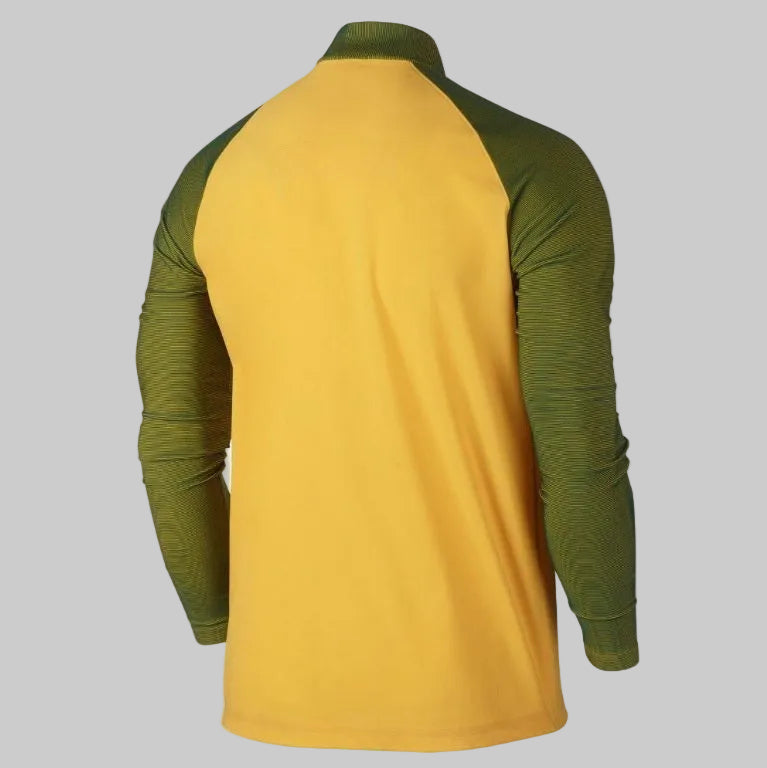 Vista posterior de la chamarra Nike Brasil Woven Elite Revolution Copa América Centenario 2016 (Ref. 802447-703) en Futbol90MX, mostrando el panel trasero liso en tono amarillo y el corte aerodinámico