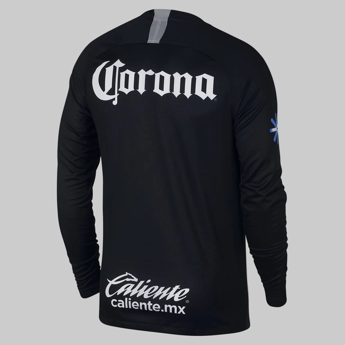 Vista posterior del jersey de portero Nike Club América 2018/19 manga larga mostrando los patrocinios oficiales de Corona y Caliente en color blanco sobre base negra, stock Futbol90MX