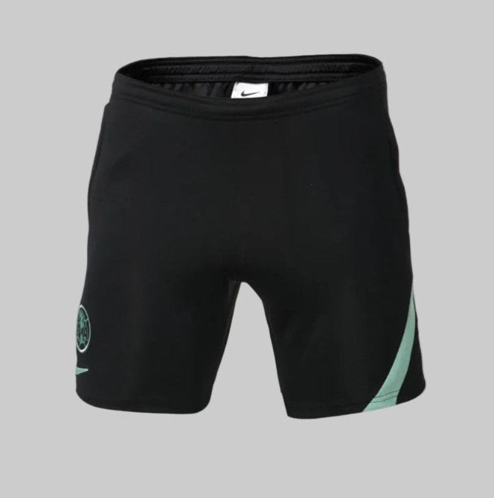 Shorts de entrenamiento Nike DH7721-010 Academy Pro Club América temporada 2021/22 en color Negro y detalles Verde Jade, vista frontal con escudo monocromático.