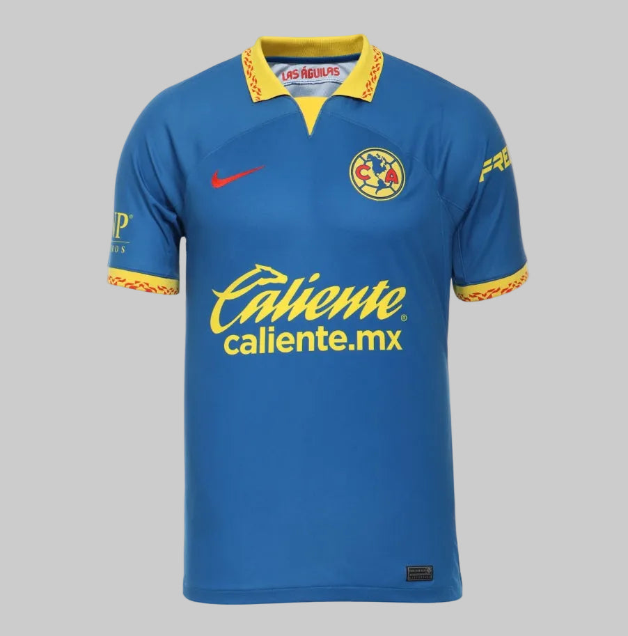 Jersey de visita Nike Club América 2023-24 color azul profundo, vista frontal con logos de Caliente.mx y escudo bordado DX2681-410