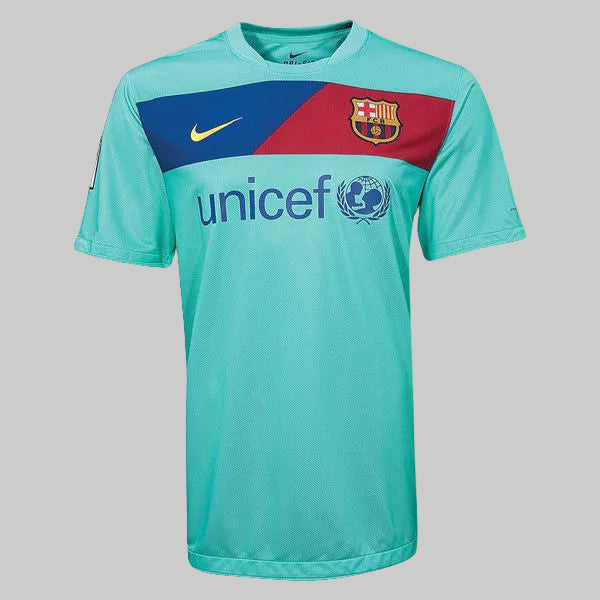 Detalle de la parte frontal del jersey away Nike del FC Barcelona 2010/11 con el escudo del club, el swoosh de Nike en amarillo y el logotipo de UNICEF en el pecho, stock Futbol90MX