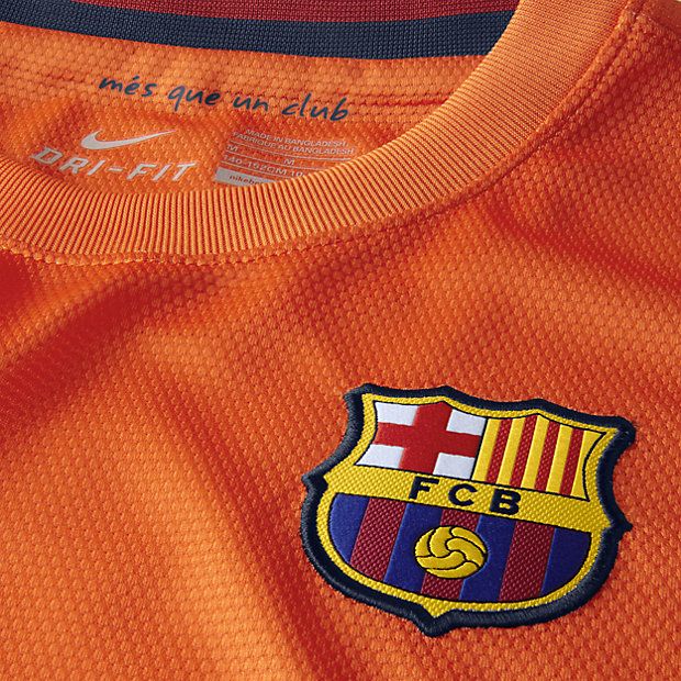 Primer plano del cuello interior y el escudo bordado del FC Barcelona en el jersey visitante 2012/13 de Messi (Ref. 478326-815) de Futbol90MX, destacando el lema institucional y el tejido con tecnología Nike