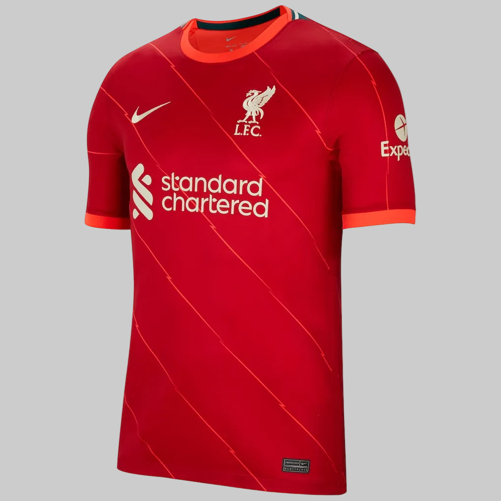 Vista frontal del jersey Nike Stadium local del Liverpool FC de Mohamed Salah (DB2560-688) de la temporada 2021/22, mostrando el color rojo con líneas diagonales de rayos y los patrocinios oficiales en Futbol90MX