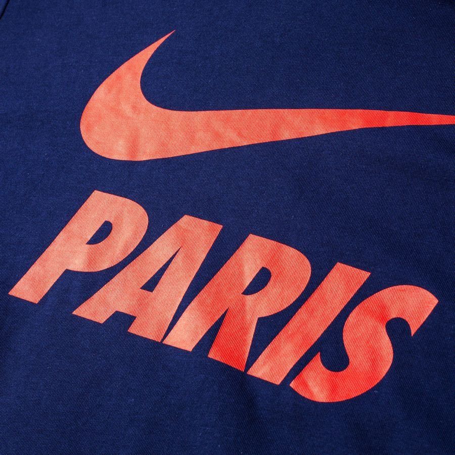 Primer plano frontal de la sudadera Core del PSG 2018/19 (892550-421), destacando el logotipo de Nike y la icónica inscripción "PARIS" en tono rojo sobre el tejido azul marino, en Futbol90MX