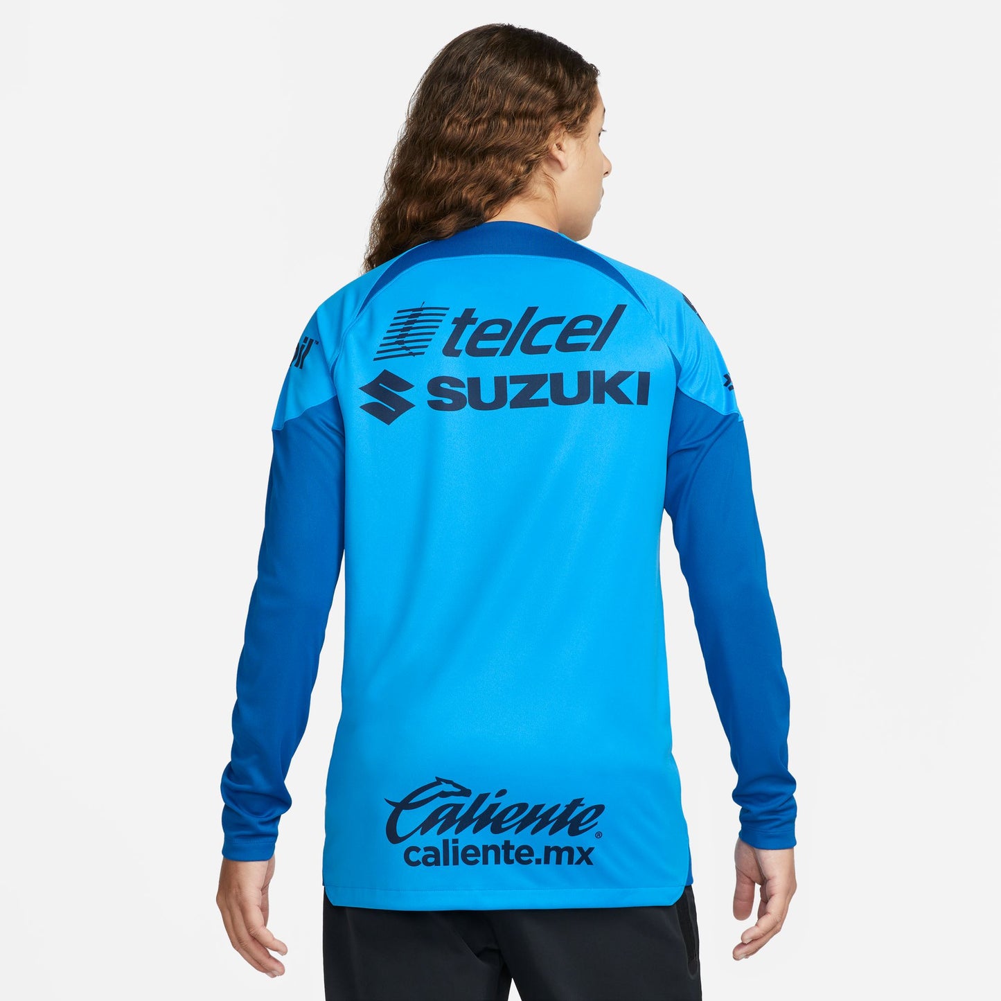Dorsal limpio del jersey de portero Pumas UNAM 2023-24 en color azul cyan vibrante con paneles oscuros en hombros y tejido transpirable Nike Dri-FIT.