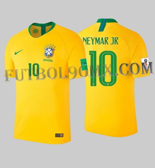 Vista dual del jersey Vapor Match de local de Brasil Mundial FIFA 2018, mostrando la tipografía técnica de torneo y la personalización oficial 'NEYMAR JR 10', codigo 893858-749, disponible en Futbol90MX