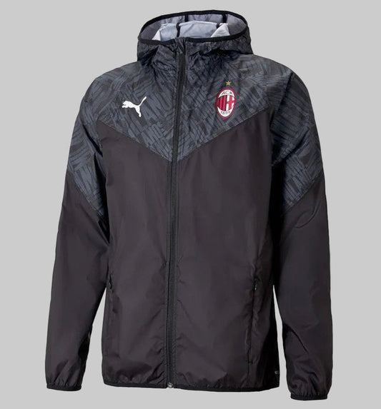 Vista frontal de la chamarra de calentamiento Puma del AC Milan 2020/21 (Ref. 758633 02) en Futbol90MX, destacando su diseño en color negro, capucha integrada con patrón tonal y el escudo oficial del club
